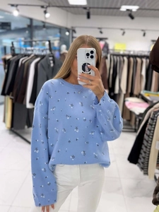 Sky blue knit pullover sweater with small floral patterns and loose crewneck fit