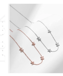 Detail of MAMA letter necklaces in silver and rose gold with sparkling pavé cubic zirconia