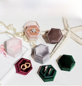 Macro detail of hexagonal velvet jewelry boxes in various colors with ring slot