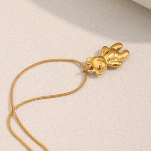 Detailed close-up of 18K gold plated teddy bear pendant on a fine snake chain necklace