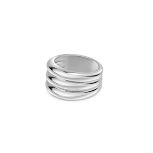 Macro shot of silver stacked wavy ring showing multi-layer design and polished metal texture