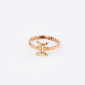 Macro detail of rose gold Gemini constellation symbol on a minimalist mirror steel ring