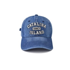 Close-up of Catalina 1983 white embroidery on blue washed denim baseball cap detail