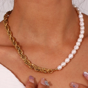 Detail of a half-gold chain and half-pearl necklace on a neck model with soft lighting