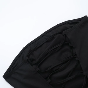 Detail of cross-straps and fine stitching on a black tube dress back view