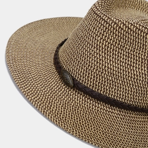 Unisex woven straw sun hat with brown leather band and vintage metal emblem for beach wear