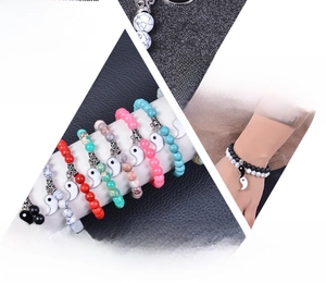 Detail of Yin Yang charms on natural stone beaded bracelets for couples in multiple colors
