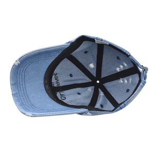 Detailed view of denim baseball cap interior featuring cotton sweatband and adjustable buckle