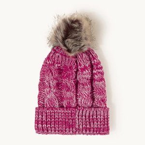Detailed view of dark pink cable knit beanie with a large faux fur pompom on top