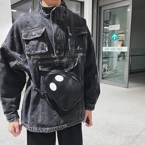 Close-up of funny ghost design cross body bag with white eyes on black matte PU leather