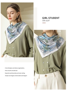 Detail view of retro printed silk scarf worn by female model with elegant drape