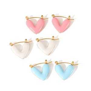 Detailed close-up of 18K gold heart earrings in pink, white, and light blue enamel