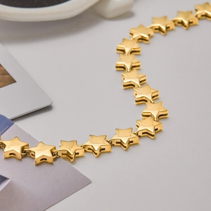 Macro detail of 18K gold star links showing the polished texture and S-curve design