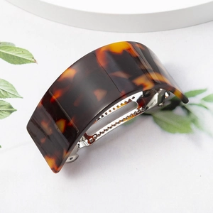 French tortoiseshell U-shaped hair clip in brown and orange acrylic with metal grip