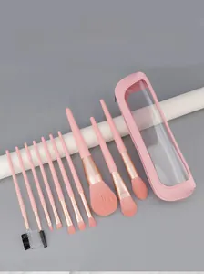 Detail of 10 pink makeup brushes with soft bristles and a matching portable storage pouch