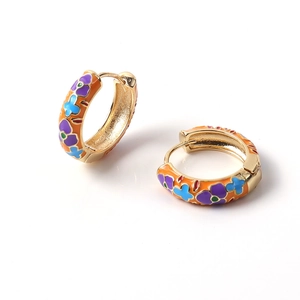 Retro gold hoop earrings with colorful enamel floral patterns on a clean white background