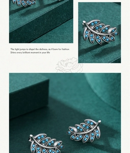 Detail of S925 silver leaf earrings featuring vintage texture and blue turquoise stones