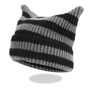 Macro shot of striped cat ear beanie showing detailed black and grey ribbed knit texture