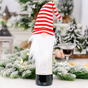 Detail of Christmas gnome wine bottle cover with red and white striped knitted hat and beard