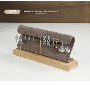 Detail view of wooden earring display stand with gray velvet panel for studs and drops