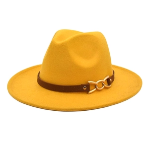 Detail of yellow wool fedora with brown faux leather band and gold metal chain buckle
