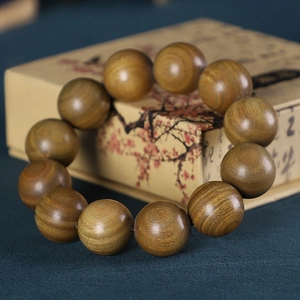 Gros plan sur des perles rondes en santal vert d'Argentine de 20mm au grain naturel