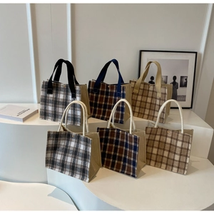 Various sizes and colors of checkered canvas tote bags with stylish rivet details