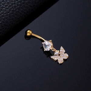 Macro shot of gold butterfly belly ring with sparkling zircon stones on black background