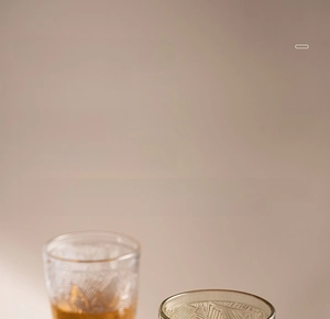 Detailed close-up of vintage embossed glass texture and smooth rolled rim on a wine goblet