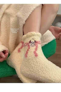 Detail of soft cream coral fleece socks with pink bow and cute puppy embroidery