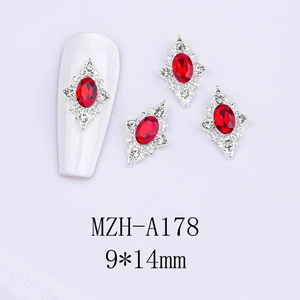 Close-up of red oval crystal nail charms with silver diamond halo, size 9x14mm