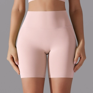 Detail of pink high waisted yoga shorts featuring seamless design and tummy control