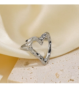 Detailed view of silver heart-shaped adjustable ring with hammered metal texture