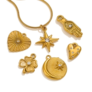 Golden stainless steel necklace set with crystal heart, star, and hamsa charms on a snake chain