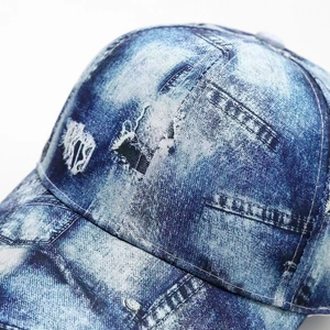 Close-up of distressed denim baseball cap detailing vintage faded texture and stitching
