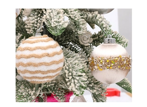 Close-up of white plush wave and pearlescent sequin beaded Christmas baubles on a tree