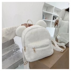 Detail of white plush backpack with cute ears and premium golden zipper hardware