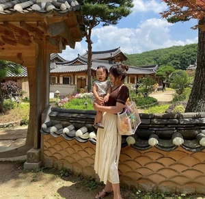 Outdoor lifestyle view of a woman carrying a large transparent PVC waterproof beach tote bag
