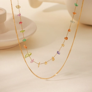 Macro view of double-layered stainless steel necklace with colorful natural gemstones