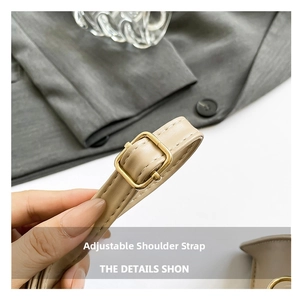 Detail of adjustable beige leather shoulder strap with high-quality gold metal buckle