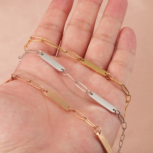 Three minimalist paperclip link bracelets in gold, silver, and rose gold with metal bar tags