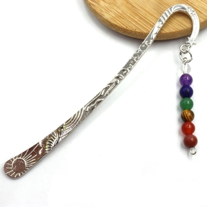 Silver feather metal bookmark with seven chakra colored beads and sun pattern detail