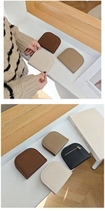 Detailed view of semi-circle lychee leather coin purses in four colors with metal zippers