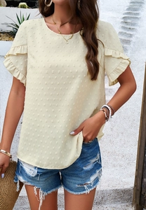 Detailed view of beige blouse with polka dot texture and elegant ruffle short sleeves