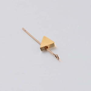 Macro detail of a golden 3D triangle geometric bead with 1.8mm hole for DIY jewelry
