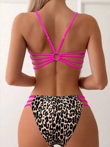 Detail of pink multi-strap bikini back with metal ring and leopard print bottom