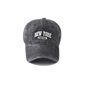 Detailed close-up of white NEW YORK 1625 embroidery on washed cotton baseball cap