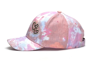 Detailed side view of a kids baseball cap with rhinestone heart and tie-dye pattern