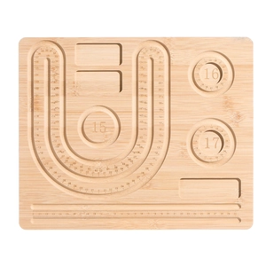 Top view of wooden jewelry design board with circular bead grooves and measurement scales