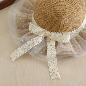 Girls' straw sun hat with white lace ribbon and gold polka dot mesh detail for summer